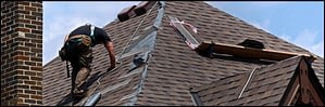 Professional roofer replacing a residential roof